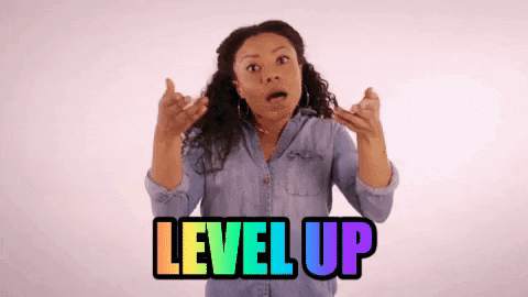 GIF of a black woman wearing a jean button-up shirt. She is raising her hands up while mouthing, "Level up". Below her, there is rainbow animated text reading "LEVEL UP".