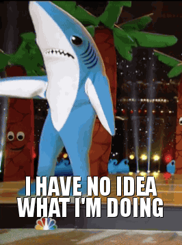 A gif of a person dressed as a sharking waving its arms with the title I have no idea what I'm doing