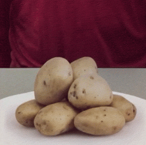 A GIF showing a plate of potatoes being lifted as a sheet of paper. 