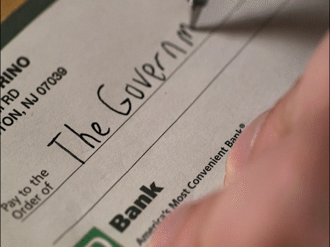 A man writes an imaginary cheque to his bank
