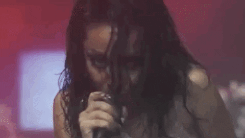 Gif of Doja Cat singing into the microphone.