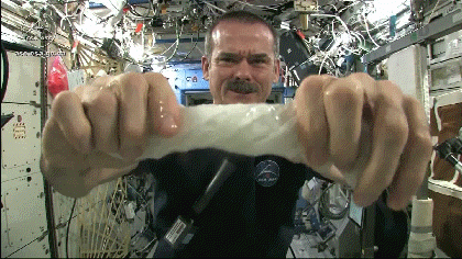 An astronaut squeezes water from a cloth while in zero gravity. 6 surprising causes of diaper leaks by LilHelper.ca Blog