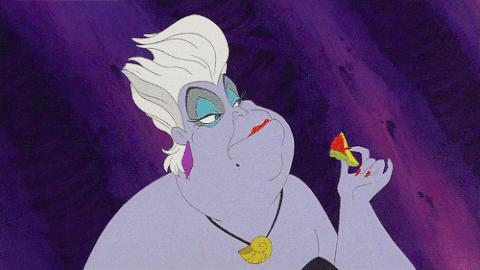 Ursula putting on lipstick and pouting