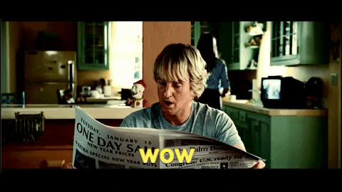 Owen Wilson reading a newspaper and saying wow.