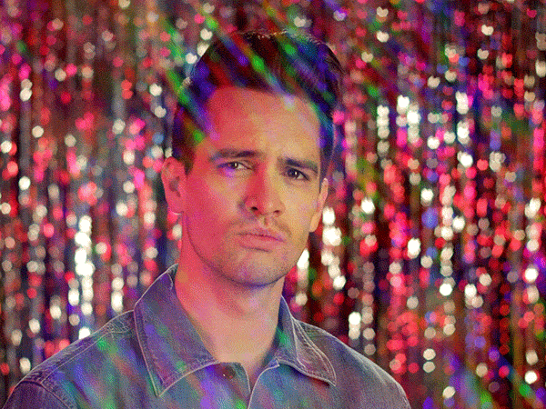 Brendon Urie in a princess tiara with a sparkly background
