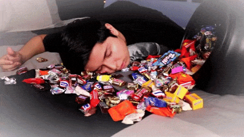 Man who has eaten lots of candies and is full and tired