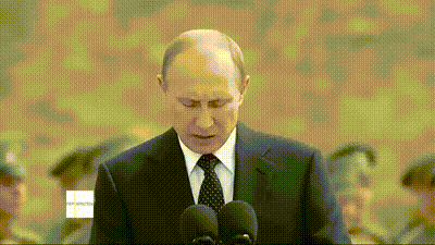Vladimir Putin speaking to the press from a podium. Vladimir Putin speaking to the press from a podium.