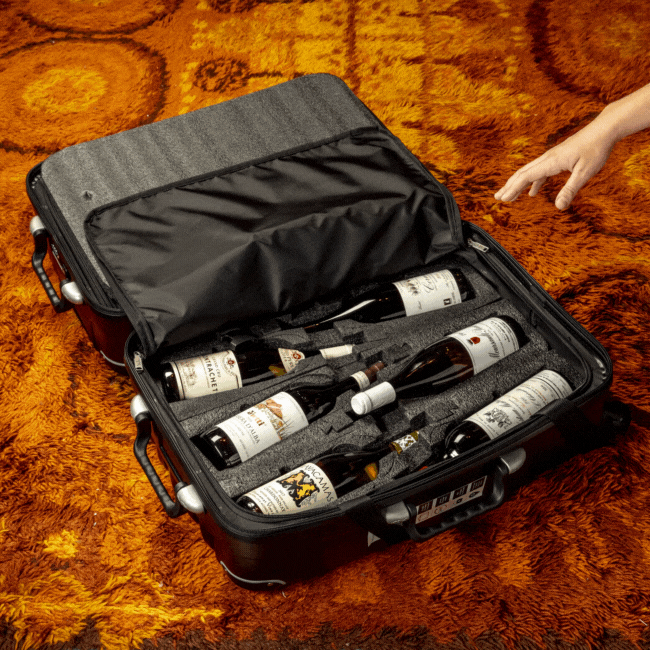 Taking a bottle out of a fly with wine suitcase.