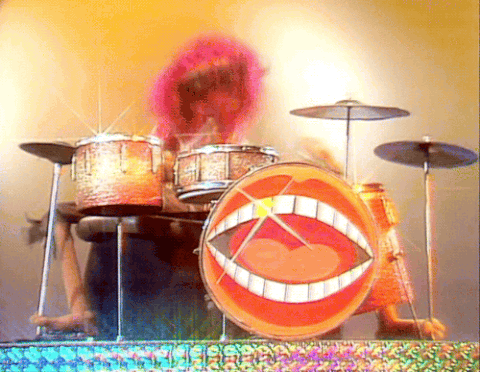 Animal from the Muppets, madly banging his drums.