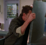 A gif of a man banging his head angrily against a counter