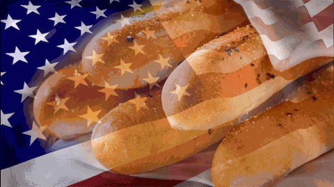 Olive Garden breadsticks in front of a waving American flag