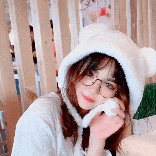 Girl wearing the plush teddy bear hat at a cafe