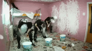 Three people painting a room. 
