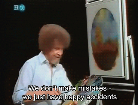 Animated gif of painter Bob Ross from his '90s TV show "The Joy of Painting," standing in front of a nature-scape with his palette in hand, saying, "We don't make mistakes - we just have happy accidents."