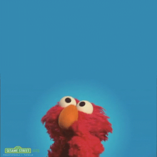 Elmo from Sesame Street taps his finger as he looks up in the air from side to side as if thinking.