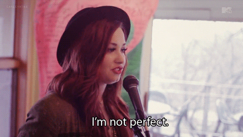 Demi Lovato speaking into a microphone.