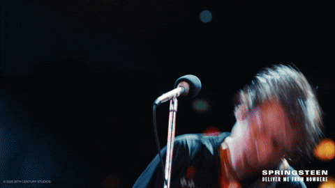 Jeremy Allen White as Springsteen singing at a mic in Springsteen: Deliver Me From Nowhere