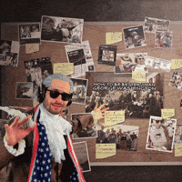 Person pinning notes and string to a conspiracy-style board, mapping out connections