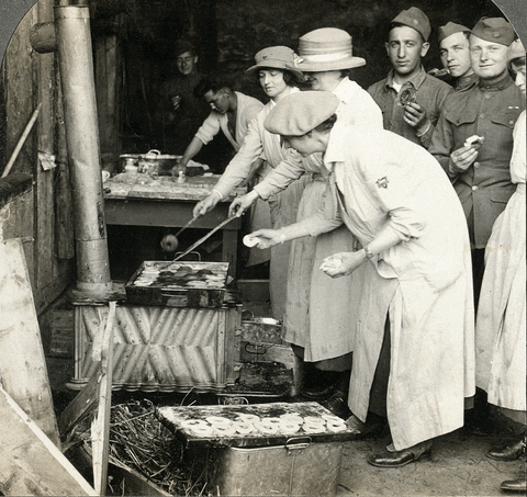 black and white image of people cooking doughnut 