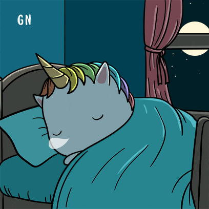unicorn sleeping on a bed comfortably 