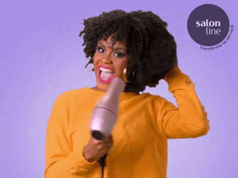 a GIF of a natural haired woman blow drying her coils