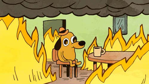 Cartoon dog sitting in a room on fire looking unfazed and content in front of a cup of coffee