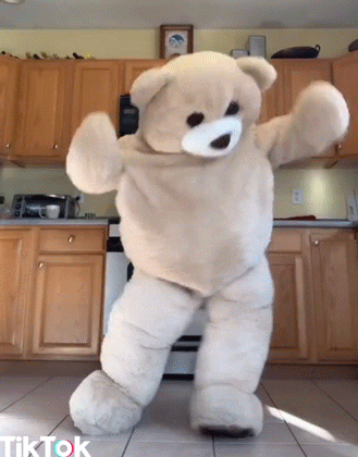 Gif of a life-size teddy bear doing a Tik Tok dance.
