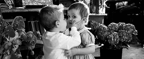 Garotinho beija a boca de garotinha surpresa