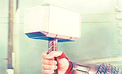 Thor grasps his hammer, symbol of power and authority.