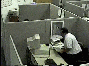 PhD Crisis - Someone pulling their hair out at a desk covered with papers and a laptop