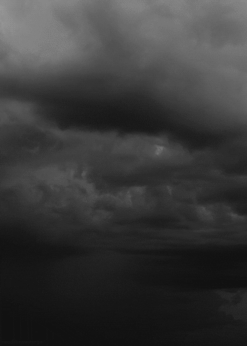 A black and white GIF of lightning striking from the clouds.