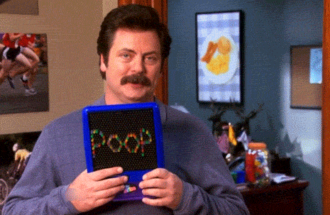 man holding Lite-Brite that spells out POOP