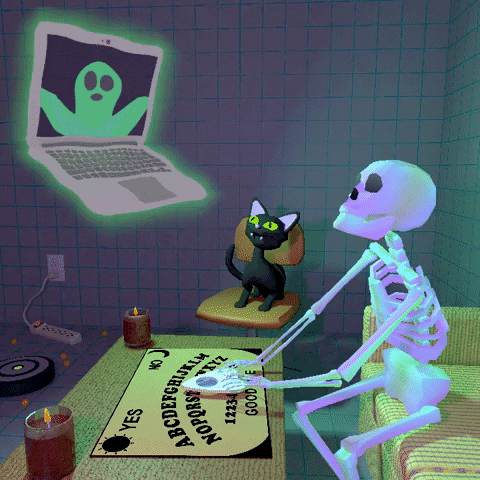 A skeleton uses a ouija board to navigate his laptop, while his cat watches. He's video calling with a ghost.