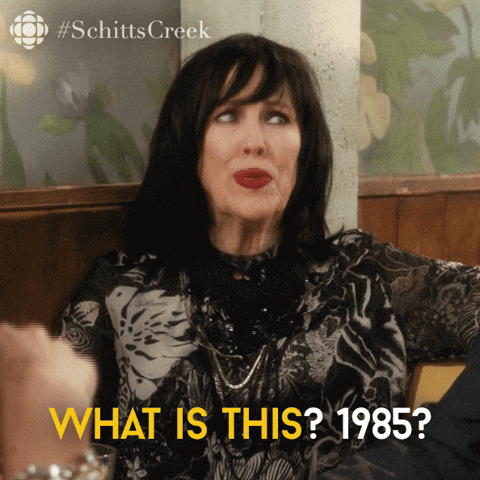 Moira from Schitts Creek saying What is this? 1985? in a GIF