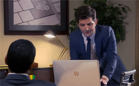 Scene from Parks & Rec. Ben is standing his desk looking at his laptop. He's disgusted by what he sees and closes it quickly, backing away.