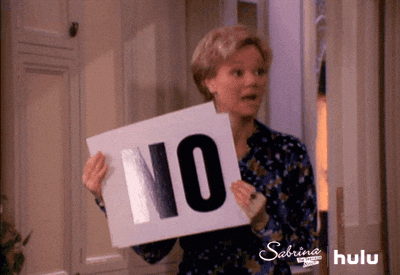 A woman showing cards saying no