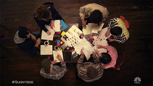 Studying in a group Group of students studying together around a table