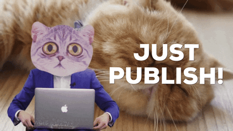 Foreground: A cat in a suit closes their laptop & gives a thumbs-up. Background: a cat naps on the floor. Caption: "Just publish!"