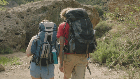 2 people playing around while hiking