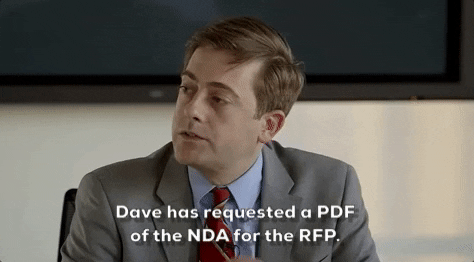 A man in a suit nods, saying, "Dave has requested a PDF of the NDA for the RFP."