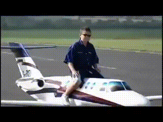 GIF image of person ridding a miniature plane