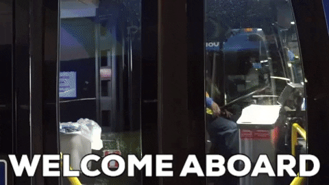 The doors on a bus open, and the driver waves. Caption: "Welcome aboard!"