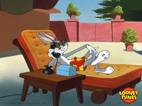 Bugs Bunny sitting on a chair and talking on the phone. Potentially someone from abroad.