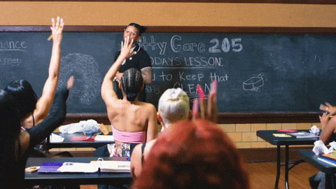 Students in class with hands raised