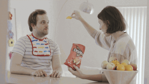A woman feeding a manchild