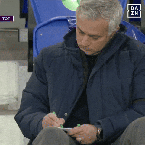 jose mourinho taking down financial advice from the dug out