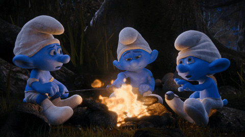 three smurfs grilling the marshmallows over a campfire