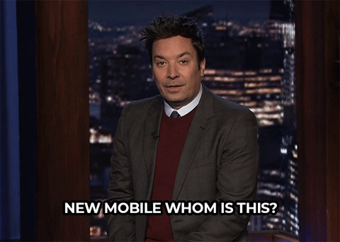 The Tonight Show: Jimmy Fallon, in a suit at his desk, says "New mobile, whom is this?"
