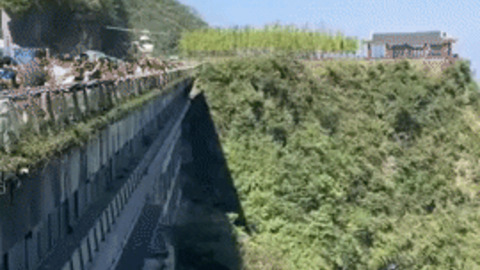 Helicopter flying off the hill gif
