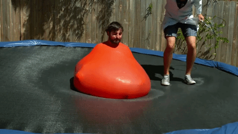 Slow Mo Guys jumping on a trampoline in a balloon